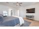 Bright bedroom featuring wood floors, an en suite, and stylish furnishings at 18438 N 96Th Way, Scottsdale, AZ 85255