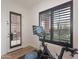 Exercise bike set up near a plantation shuttered window and door at 18438 N 96Th Way, Scottsdale, AZ 85255