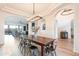 Open-concept dining area features a rustic table, seating for six, and elegant lighting at 18438 N 96Th Way, Scottsdale, AZ 85255