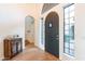 Beautiful entryway showcases a wood door, sidelights, and wood flooring at 18438 N 96Th Way, Scottsdale, AZ 85255