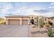 Beautiful desert home showcasing a spacious driveway, desert landscaping, and a tiled roof at 18438 N 96Th Way, Scottsdale, AZ 85255