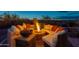 A cozy outdoor fire pit area with comfortable seating, perfect for evening gatherings and relaxation at 18438 N 96Th Way, Scottsdale, AZ 85255