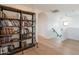 Upstairs hallway features hardwood floors and a large bookshelf at 18438 N 96Th Way, Scottsdale, AZ 85255