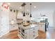 Spacious kitchen featuring an island, granite countertops, stainless appliances, and decorative backsplash at 18438 N 96Th Way, Scottsdale, AZ 85255