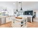 Bright kitchen with granite countertops, a central island, stainless steel appliances, and hardwood floors at 18438 N 96Th Way, Scottsdale, AZ 85255