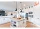 Gourmet kitchen featuring stainless appliances and a large island with counter seating at 18438 N 96Th Way, Scottsdale, AZ 85255