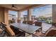 Relaxing outdoor dining area with a long table and comfortable seating perfect for Gathering gatherings and entertaining guests at 18438 N 96Th Way, Scottsdale, AZ 85255