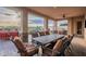 Covered patio with seating and view of pool and landscaping at 18438 N 96Th Way, Scottsdale, AZ 85255