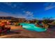 Inviting pool with waterfall feature, seating area, and lush landscaping offers a perfect backyard oasis at 18438 N 96Th Way, Scottsdale, AZ 85255