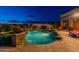 An exquisite pool area featuring a waterfall, lush landscaping, and a relaxing outdoor seating area at 18438 N 96Th Way, Scottsdale, AZ 85255