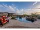 Beautiful backyard pool with a waterfall feature, lush landscaping, and lounge chairs at 18438 N 96Th Way, Scottsdale, AZ 85255