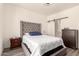 Bedroom featuring upholstered headboard, wood nightstands, and barn door to the bathroom at 1851 E Frye Rd # 101, Gilbert, AZ 85295