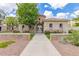 Charming community entrance featuring gated access, beautiful landscaping, and stone accents at 1851 E Frye Rd # 101, Gilbert, AZ 85295