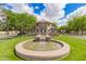Community fountains surrounded by lush greenery and mature trees at 1851 E Frye Rd # 101, Gilbert, AZ 85295