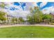 Beautiful community pond view with benches, walking path, and attractive residential buildings in the background at 1851 E Frye Rd # 101, Gilbert, AZ 85295