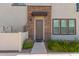 Charming front door features a stone facade and is accompanied by desert landscaping at 1851 E Frye Rd # 101, Gilbert, AZ 85295