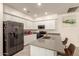 Well-lit kitchen featuring stainless steel appliances and gray quartz countertops and island at 1851 E Frye Rd # 101, Gilbert, AZ 85295