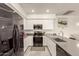 Bright kitchen features stainless steel appliances, white cabinets, and gray quartz countertops at 1851 E Frye Rd # 101, Gilbert, AZ 85295