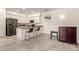 Modern kitchen with sleek white cabinets, an island with bar seating, and stainless appliances at 1851 E Frye Rd # 101, Gilbert, AZ 85295