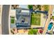 A high angle aerial view shows the roof, driveway, backyard, and swimming pool of a home at 1868 E La Donna Dr, Tempe, AZ 85283