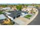 Aerial view of a modern home showcasing a dark roof, well-manicured landscaping, and a spacious driveway at 1868 E La Donna Dr, Tempe, AZ 85283