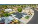 Stunning aerial view of a modern home featuring a dark roof, a well-manicured lawn, and a spacious driveway at 1868 E La Donna Dr, Tempe, AZ 85283