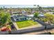 An aerial view showcases a home with a well-maintained yard, bordered by a block fence and desert landscaping at 1868 E La Donna Dr, Tempe, AZ 85283
