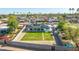 An aerial view of a home with a pristine lawn, surrounded by a block fence and desert landscaping at 1868 E La Donna Dr, Tempe, AZ 85283