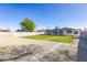 Spacious backyard with lush lawn, stone pavers, and mature trees at 1868 E La Donna Dr, Tempe, AZ 85283
