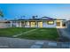 Large backyard featuring lush green grass, stepping stones, and a covered patio, ideal for relaxation and entertainment at 1868 E La Donna Dr, Tempe, AZ 85283