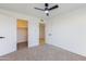 Bedroom featuring neutral carpet, white walls, ceiling fan, and closet at 1868 E La Donna Dr, Tempe, AZ 85283