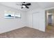 Bright bedroom features neutral carpet, a ceiling fan, and sliding closet doors at 1868 E La Donna Dr, Tempe, AZ 85283