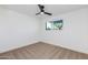 Bedroom featuring neutral carpet, white walls, ceiling fan, and bright window at 1868 E La Donna Dr, Tempe, AZ 85283