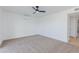 Bright bedroom featuring neutral carpet, white walls, ceiling fan, and air conditioning unit at 1868 E La Donna Dr, Tempe, AZ 85283
