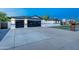 Beautiful home exterior featuring a dark garage, manicured front yard, and a well-maintained driveway at 1868 E La Donna Dr, Tempe, AZ 85283