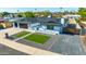 A two-car garage and a lush green area lead to this beautiful home's front entryway at 1868 E La Donna Dr, Tempe, AZ 85283