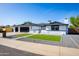 Beautiful one-story home with a three-car garage, attractive landscaping, and a welcoming entrance at 1868 E La Donna Dr, Tempe, AZ 85283