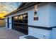 Contemporary garage with black framed windows, stylish exterior lighting, and a sleek, modern design at 1868 E La Donna Dr, Tempe, AZ 85283