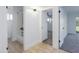 Hallway featuring tile flooring, leads to a bedroom with carpet, and a bathroom at 1868 E La Donna Dr, Tempe, AZ 85283