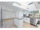 Beautiful eat-in kitchen features granite counters, white cabinetry, stainless appliances, and a skylight at 1868 E La Donna Dr, Tempe, AZ 85283