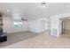 Open-concept living room with fireplace, ceiling fan, tile flooring, and abundant natural light at 1868 E La Donna Dr, Tempe, AZ 85283