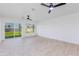 Spacious living room with sliding glass doors leading to the backyard, complemented by dual ceiling fans at 1868 E La Donna Dr, Tempe, AZ 85283