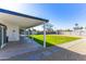 Covered patio overlooks a large backyard with grass, pavers, and gravel at 1868 E La Donna Dr, Tempe, AZ 85283