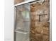 Elegant tiled shower stall with glass door, niche, and sleek fixtures at 1868 E La Donna Dr, Tempe, AZ 85283
