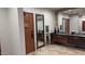 Community bathroom with large mirrors, multiple sinks, and a door that leads to the sauna and spa at 1945 W Desert Vista Trl # 77, Phoenix, AZ 85085