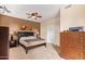 Cozy bedroom with a comfortable bed, ceiling fan, and ample storage space in the wooden dresser at 1945 W Desert Vista Trl # 77, Phoenix, AZ 85085
