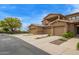 Exterior townhome facade featuring private balcony, stone accents, and spacious two-car garages at 1945 W Desert Vista Trl # 77, Phoenix, AZ 85085