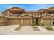 Exterior townhome facade featuring private balcony, stone accents, and spacious two-car garages at 1945 W Desert Vista Trl # 77, Phoenix, AZ 85085