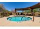 A soothing hot tub with lounge chairs and a relaxing pergola overlooks a desert landscape at 1945 W Desert Vista Trl # 77, Phoenix, AZ 85085