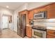 Kitchen featuring stainless steel appliances and oak cabinets with tiled backsplash at 1945 W Desert Vista Trl # 77, Phoenix, AZ 85085